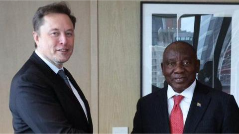 Elon Musk stands next to Cyril Ramaphosa, the president of South Africa