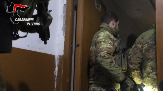 Italian police in camouflage uniform are seen entering a building