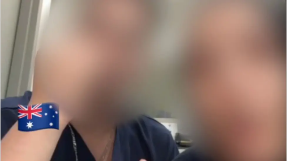 A screenshot from a video shows two nurses in blue scrubs with their faces blurred. An Australian flag emoji is visible.